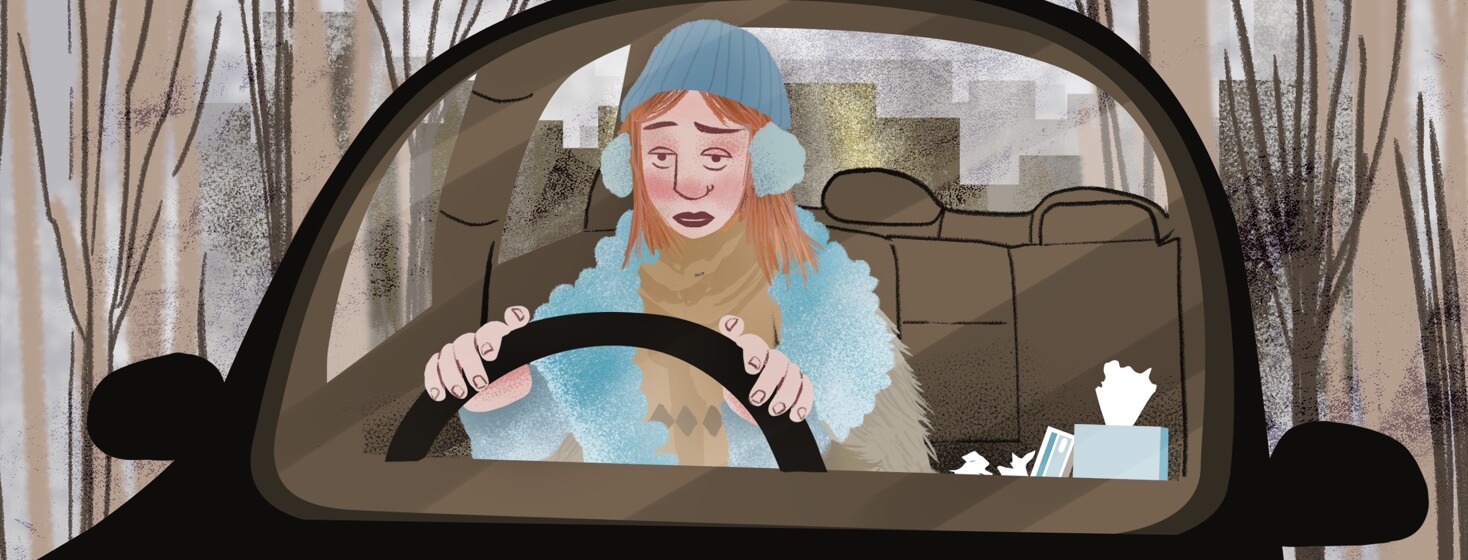 alt=a woman suffering from allergies drives through a cold front in a forest