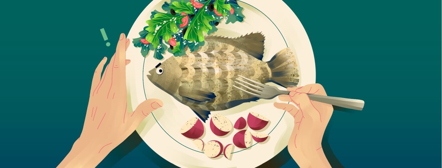 alt=a person about to eat a sinister-looking tilapia